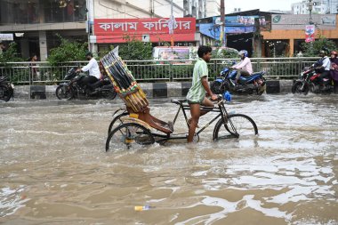 Vehicles and Rickshaws try driving with passengers through the waterlogged streets of Dhaka after heavy rainfalls caused almost-standstill, on September 3, 2024.  clipart