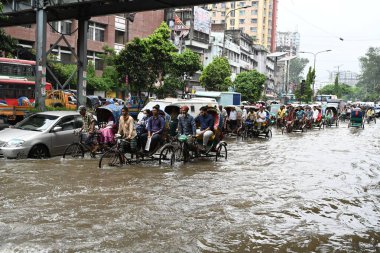 Vehicles and Rickshaws try driving with passengers through the waterlogged streets of Dhaka city after heavy rainfalls caused almost-standstill, in Bangladesh, on October 3, 2024.  clipart