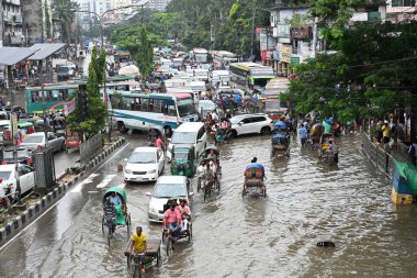 Vehicles and Rickshaws try driving with passengers through the waterlogged streets of Dhaka city after heavy rainfalls caused almost-standstill, in Bangladesh, on October 3, 2024.  clipart