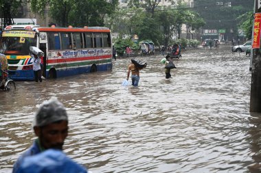 Vehicles and Rickshaws try driving with passengers through the waterlogged streets of Dhaka city after heavy rainfalls caused almost-standstill, in Bangladesh, on October 5, 2024.  clipart