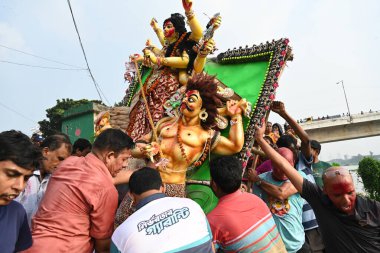 Bangladeshi Hindu devotees immerse an idol of Hindu Goddess Durga into the river Buriganga in Dhaka, Bangladesh, on October 13, 2024.  clipart