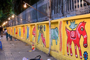 Dhaka Üniversitesi Güzel Sanatlar Fakültesi öğrencisi, Bangladeş, Dhaka 'daki Bengali Yeni Yıl kutlamaları öncesinde 9 Nisan 2025' te bir dekoratif duvar resmine son rötuşlarını yapıyor.. 