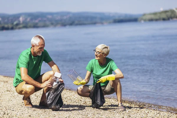 Mature Volunteers Gathering Garbage River Bank Ecology Concept — Stok fotoğraf