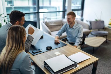Human resource team talking to a candidate during a job interview in the office.