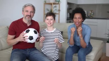 Excited family football fans watching sport tv game celebrating goal together