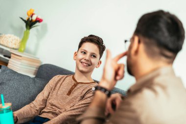 Single father and son spending time together at home and having fun.