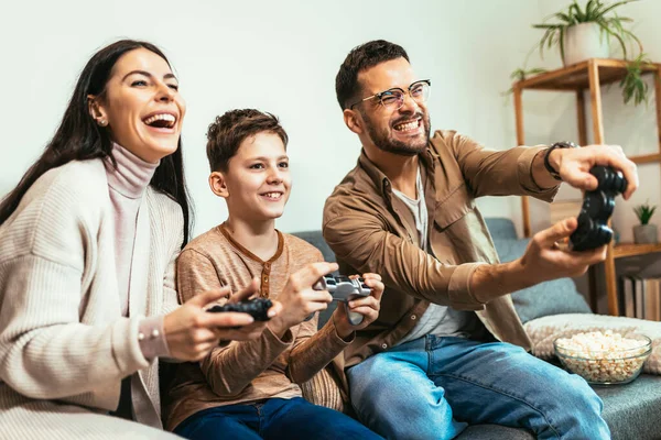 Happy family playing video games at home and having fun together.