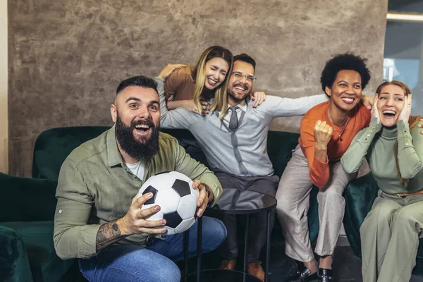 Group of friends watching game in cafe. Friends sitting at a cafe public place screaming and shouting feels overjoyed and happy by their favorite football club team winning