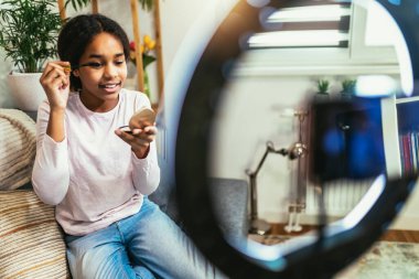 Teenager Girl Making A Video Blog On A Smartphone At Her Home. Beauty, makeup