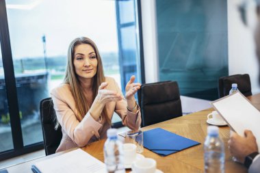 Group of businesspeople having a briefing in a boardroom. Businesspeople working together in a modern workplace.