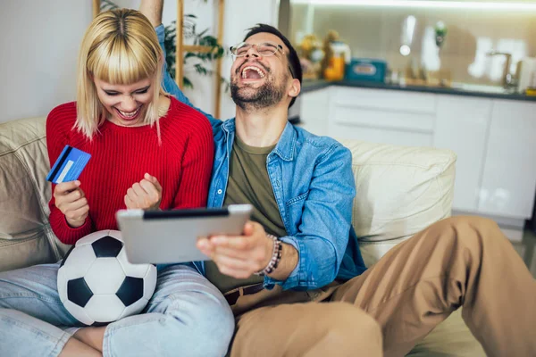Young Couple Watching Football Game Digital Tablet Using Credit Card — Stock Photo, Image