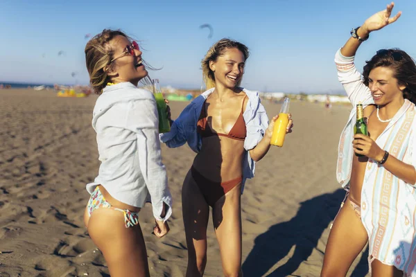 在阳光灿烂的日子里在海滩上玩得开心的女性朋友 — 图库照片