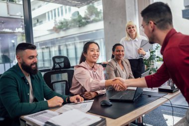 Human resource team talking to a candidate during a job interview in the office.