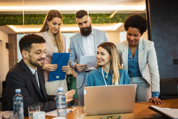 Team brainstorming. Group of business people working together on a laptop