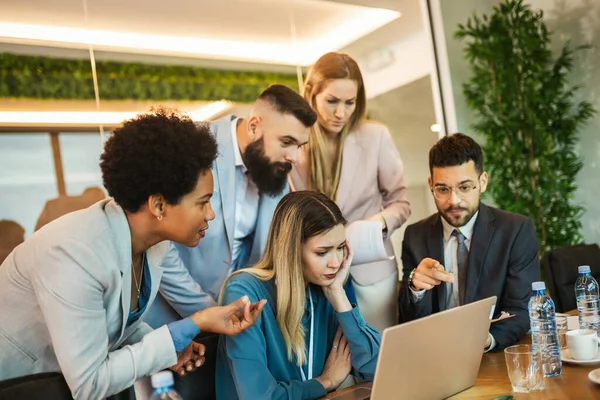 stock image Team brainstorming. Group of business people working together on a laptop