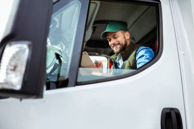 Çekici servisinde çalışan ve kamyonunu süren yakışıklı bir genç..