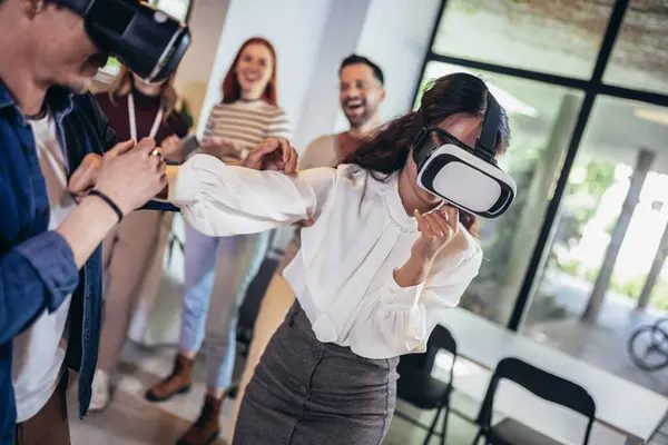 Business people making team training exercise during team building seminar using VR glasses