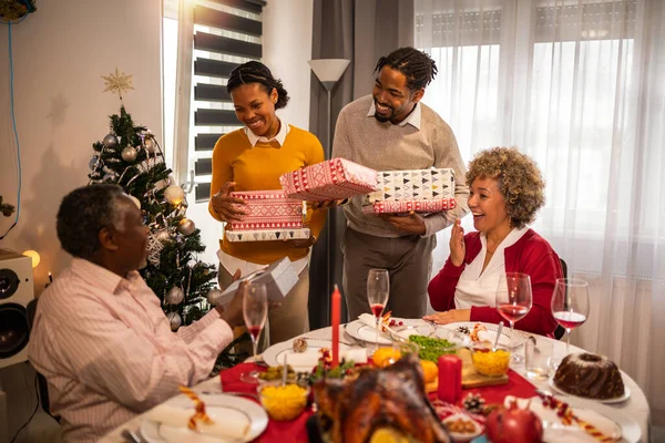 Giving Gifts Grandparents Christmas Dinner — Stock Photo, Image