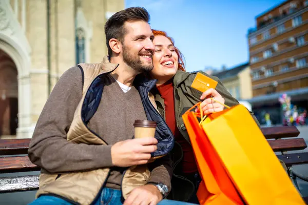 幸福夫妇与购物袋的肖像在城市购物后微笑和持有信用卡 — 图库照片