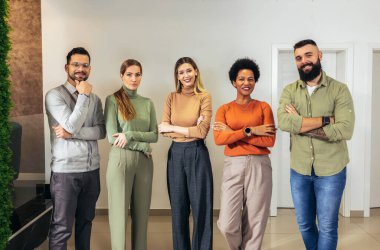 Successful group of business people at modern office looking at camera.