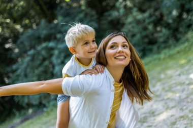 Genç ve güzel anne, oğluyla oynuyordu..