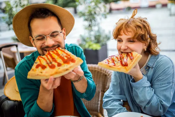 Restorandaki çift ketçaplı lezzetli pizzalar yiyor..