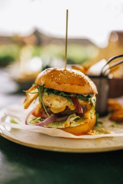 Restoranda servis edilen patates kızartmalı ve ketçaplı lezzetli görünümlü hamburger..