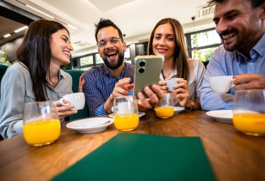 Bir arkadaş grubu kafede buluştu. Telefondaki resimlere bakıyorum. Birlikte eğleniyoruz..