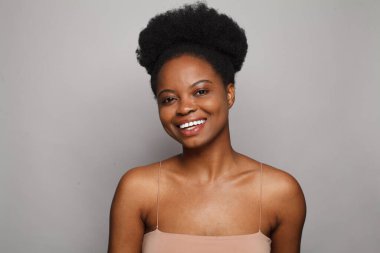 Beautiful friendly woman with fresh clean skin and positive smile on white studio wall background. Beauty, facial treatment, skin care and wellness concept