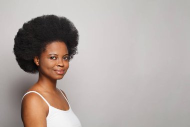 Optimistic cute young woman with fresh clear healthy skin on white background. Beauty, facial treatment, skin care and cosmetology concept