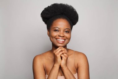 Pretty lady smiling on gray background. Beautiful female face portrait