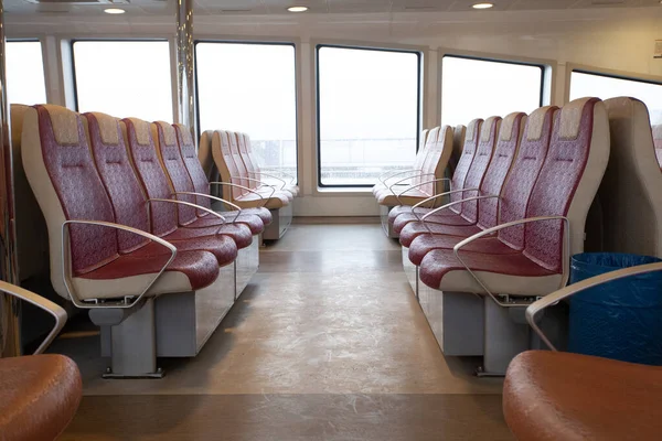 Red seats in ferry over Bosporus in Istanbul, Turkey.