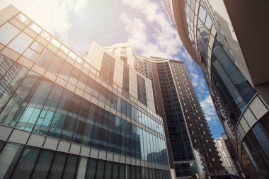 Skyscarpers of steel and glass on the background of beautiful cloudy sky