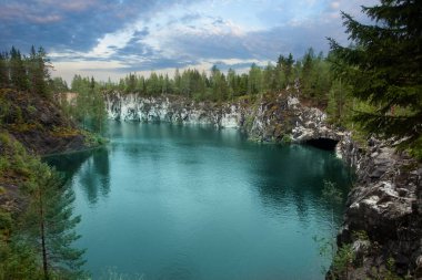 Cute landscape of cloudy sky, green forest and beautiful mountain river