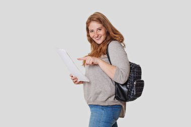 Mutlu kadın, beyaz stüdyo geçmişine ait belgeleri gösteriyor.