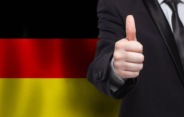 Německý Koncept Podnikatel Ukazuje Palec Nahoru Pozadí Vlajky Německa — Stock fotografie
