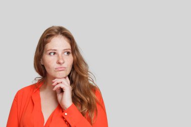 Beyaz arka planda düşünceli çekici bir kadın. Şüphe ve fikir kavramı