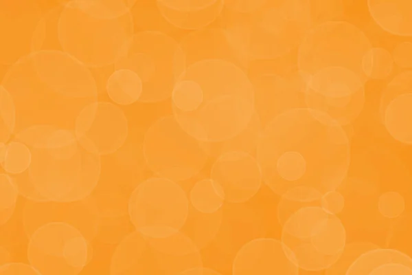 Bright orange bokeh background. Birthday, Christmas or New Year holidays template. Abstract glitter defocused blinking bubble and sparkle.