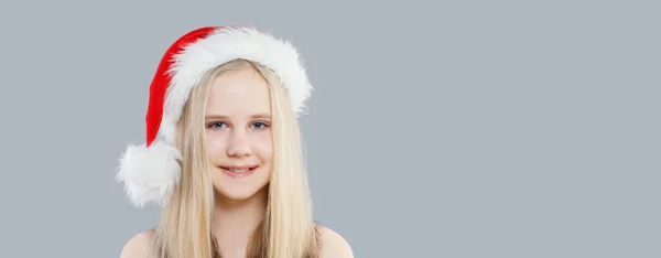 Liten Flicka Bär Santa Hatt Grå Fana Bakgrund Jul Porträtt — Stockfoto