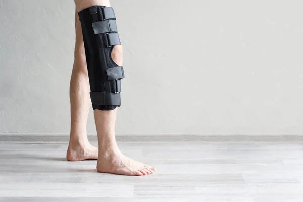 Man wearing knee brace closeup. Help promote recovery of bones, muscles, ligaments