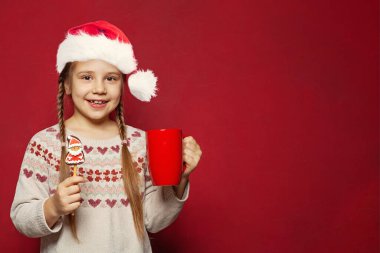 Noel çocuğu. Mutlu şirin kız Noel Baba Noel Baba. Kurutma ve kırmızı pankartta yemek.