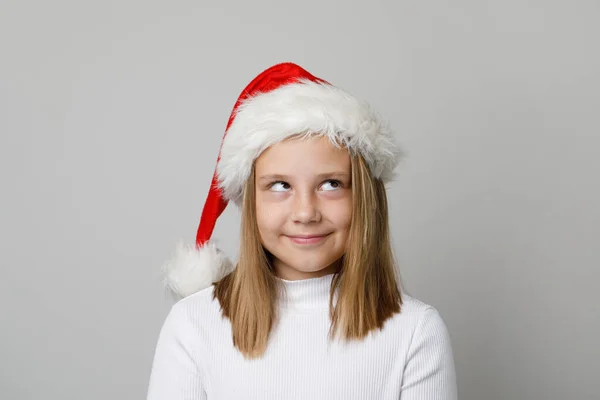Noel Baba Şapkalı Şirin Yaramaz Kız Beyaz Arka Plana Bakıyor — Stok fotoğraf