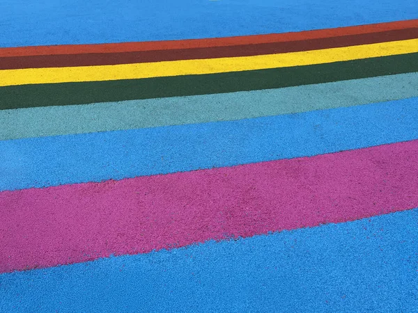 Colorful rubber floor playground background. Padded floor covering with rubber granules. Special rubber coating for the playground or sports activity