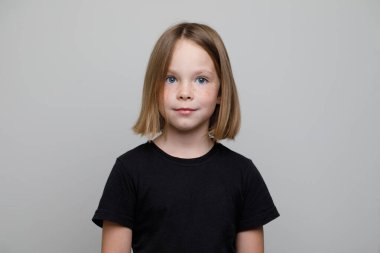 Kısa saç portresi olan sevimli, neşeli küçük bir kız. Kahverengi saçlı çocuk.