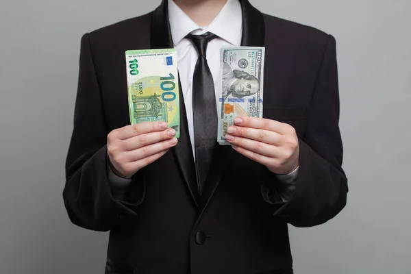 Young adult businessman showing money cash US Dollar and Euro banknote. Business, currency exchange, deal, salary and credit concept