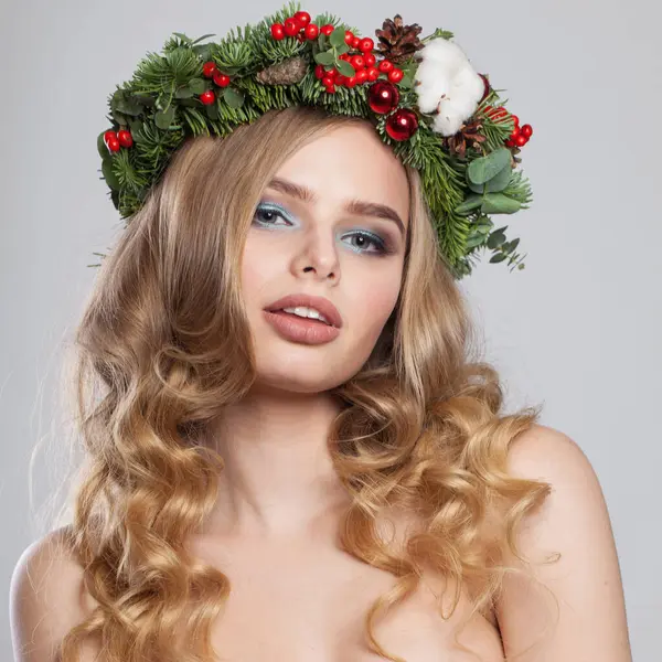 Christmas beauty woman. model with makeup, clean fresh skin, wavy blonde hair, perfect smile and Xmas New Year decoration