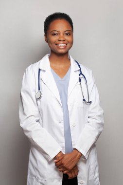 Beyaz arka planda laboratuvar önlüğüyle güzel görünümlü mutlu doktor kadın doktor.