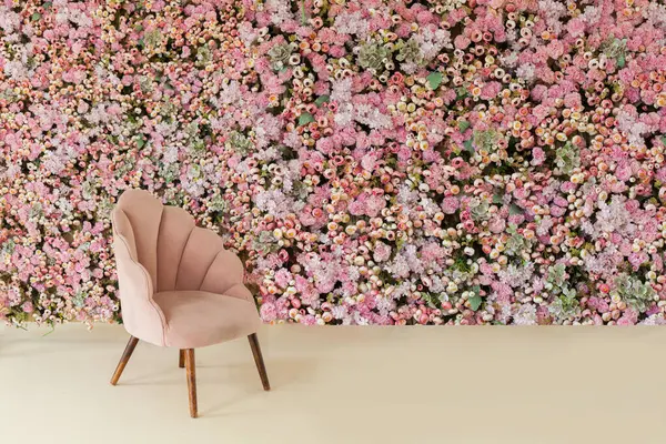 Pink furniture and interior home decoration background. Velvet velor armchair against floral wall