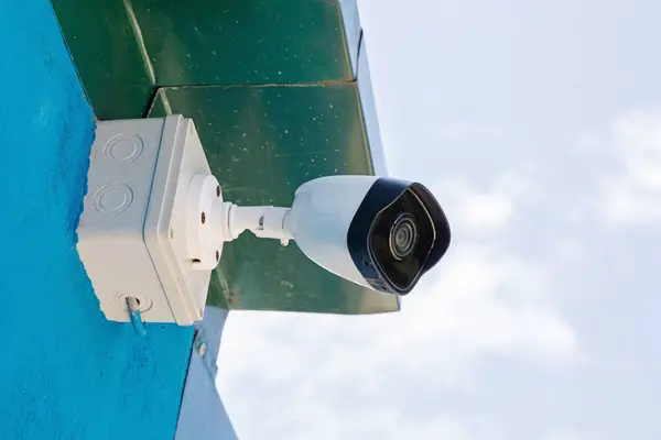 Home with security camera installed on the underside of its roof