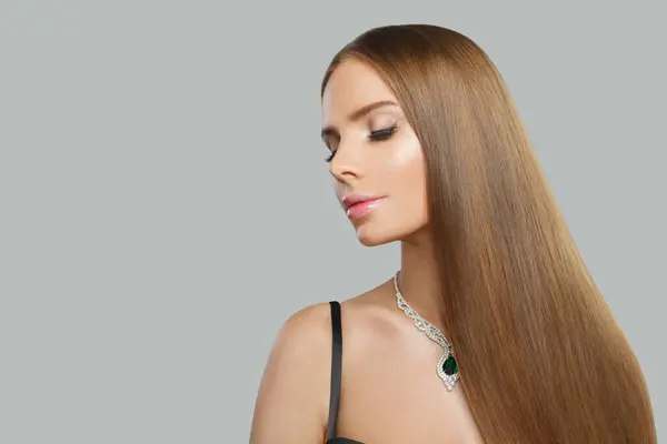 Pretty jewelry model beautiful woman portrait. Brunette woman with long smooth hair and necklace